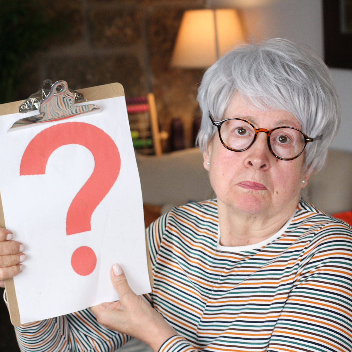Senior lady holding question mark
